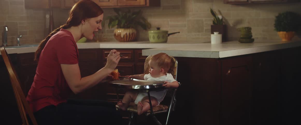 A mother feeding a baby