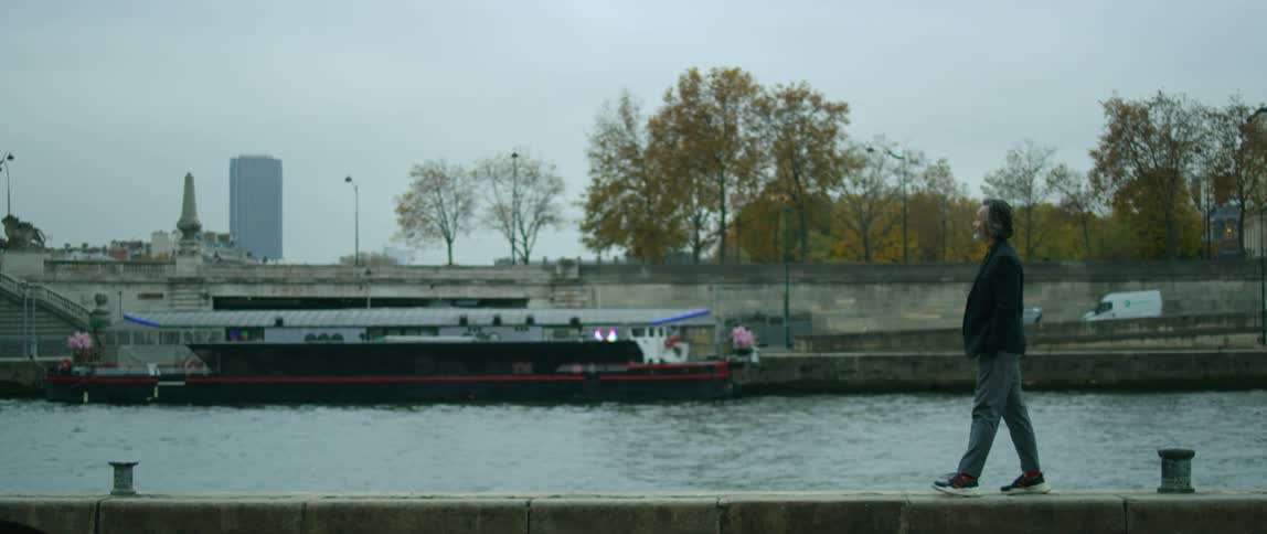 A man walking next to a river