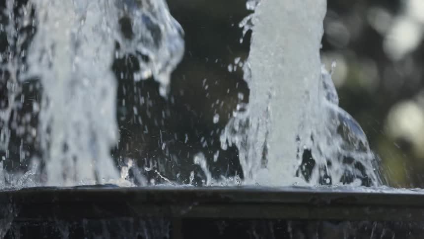 Twin water spouts fall into fountain and over the side