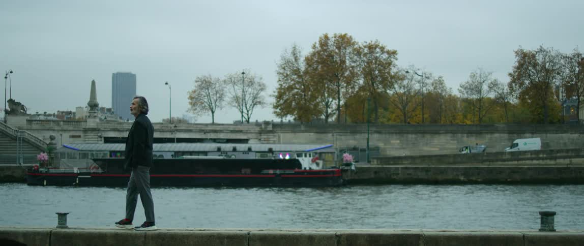 A man walking next to a river