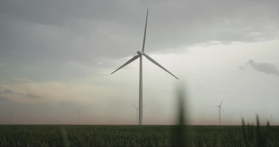 Blades of a wind turbine spin on a windy day