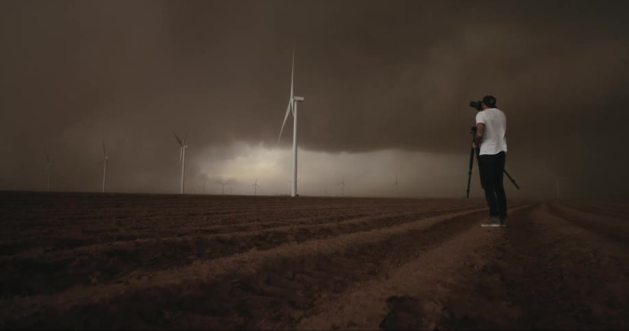 A man is photographing a storm
