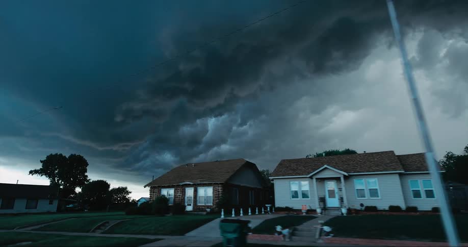 Dark storm clouds over houses in a neighborhood