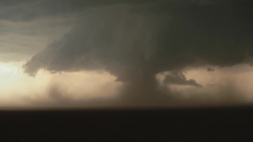 A large formation of storm clouds are seen in the distance and look ominous