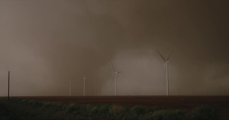 Dark storm clouds form over a wind farm