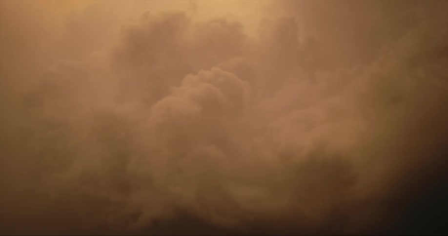 Dense clouds swirl and turn dark in the sky