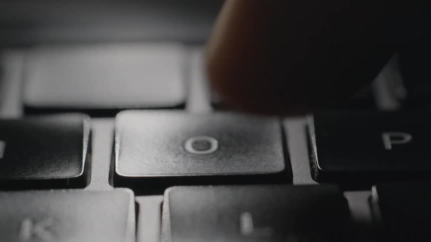 A key hitting a key on a keyboard