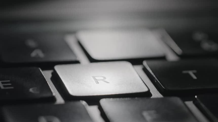 A view of a person touching a key on a keyboard