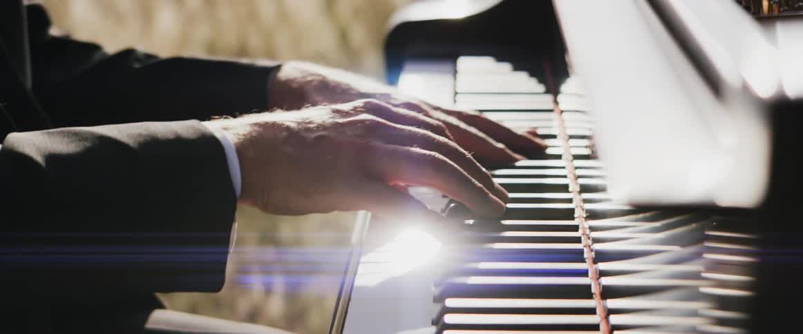 A person playing a piano outdoors