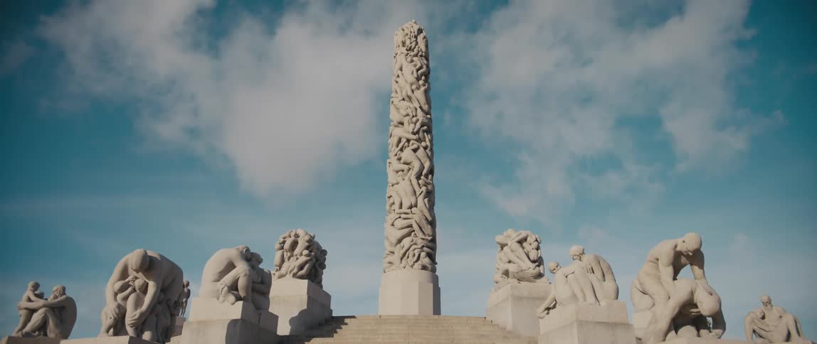 Gustav Vigeland's Monolith in Oslo, Norway, consisting of 121 sculpted human figures, at the top of steps lined with more human figures.