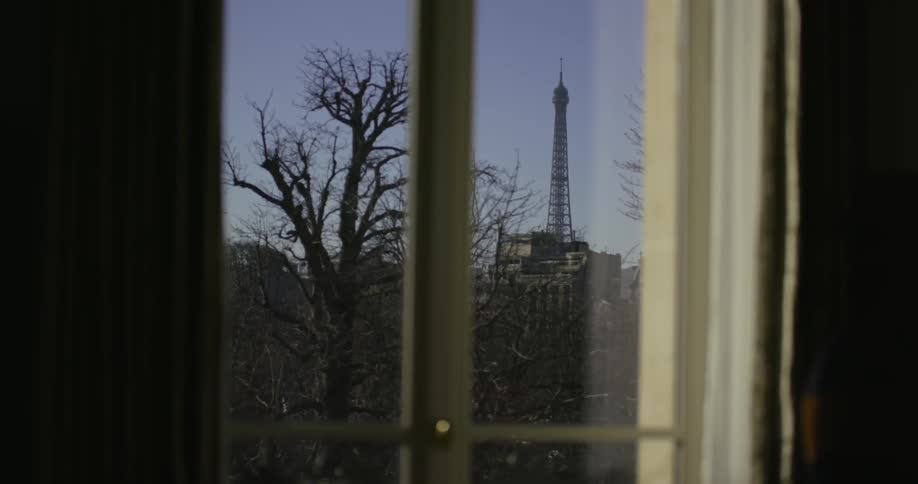 A person walks past a window indoors