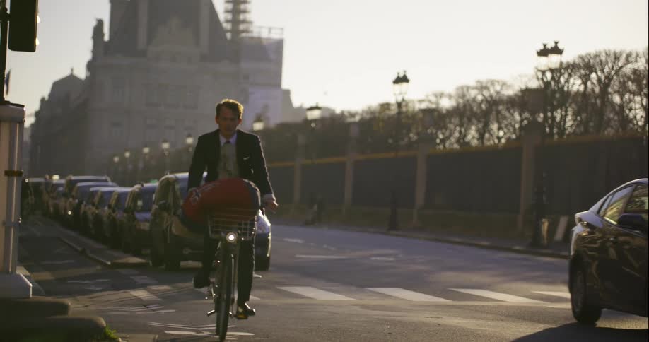 Man riding a bicycle down a street