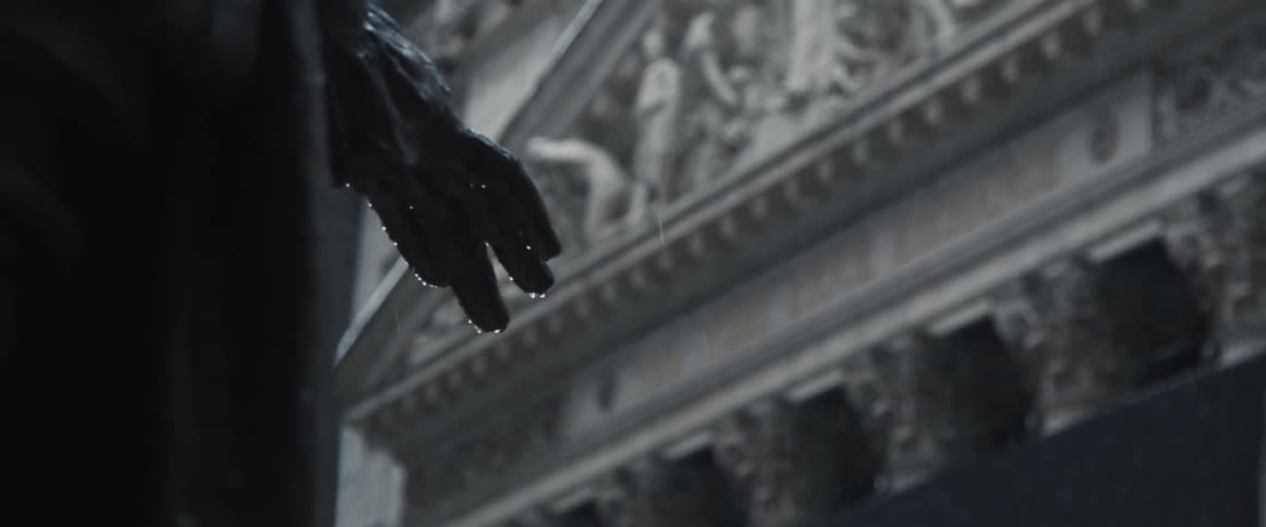 A statue and the facade of the new york stock exchange in the snow