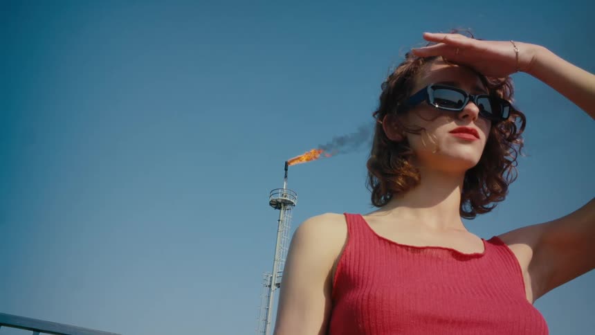 A woman is looking around outside