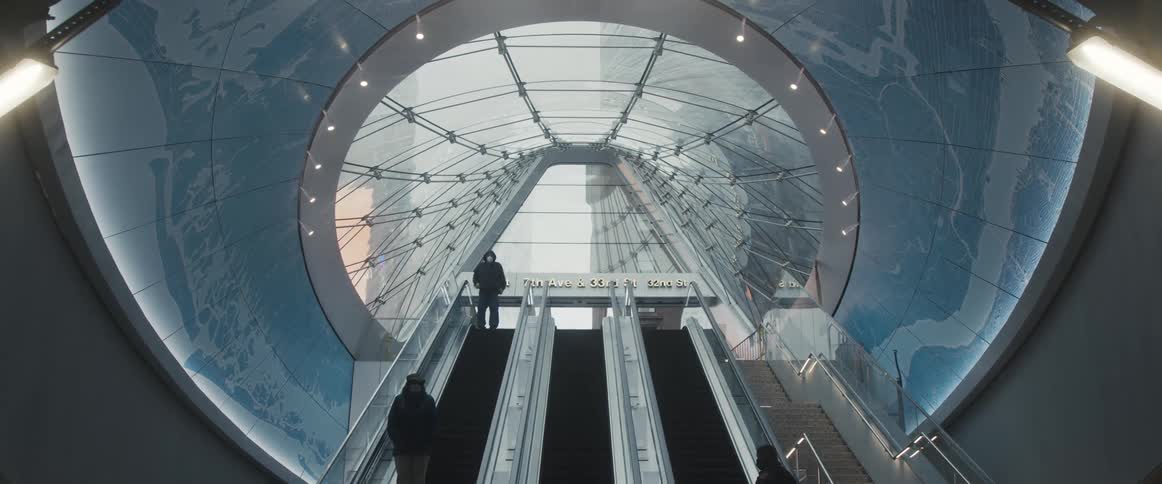 People ride a trio of escalators in an office building