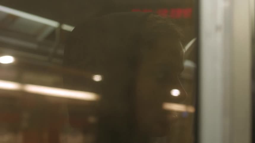 A man looks through a subway window