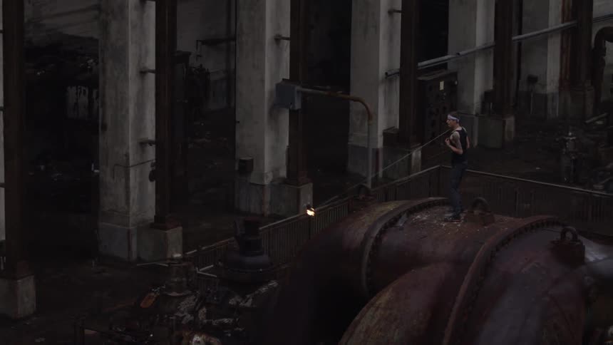 A man swinging a chain with fire on the end