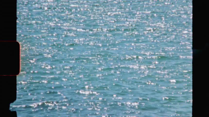 Sunlight reflects on the ripples of the ocean during the day
