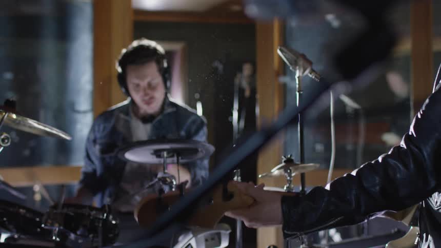 Musicians playing several instruments in a studio