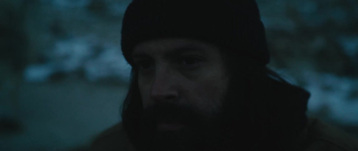 A man is standing outside in the cold