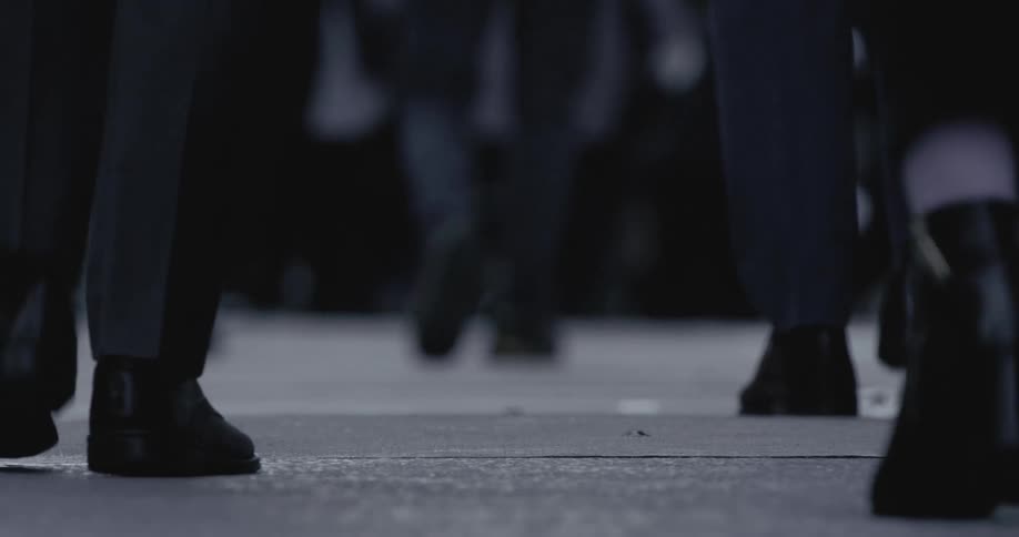 Pedestrians walk along the sidewalk