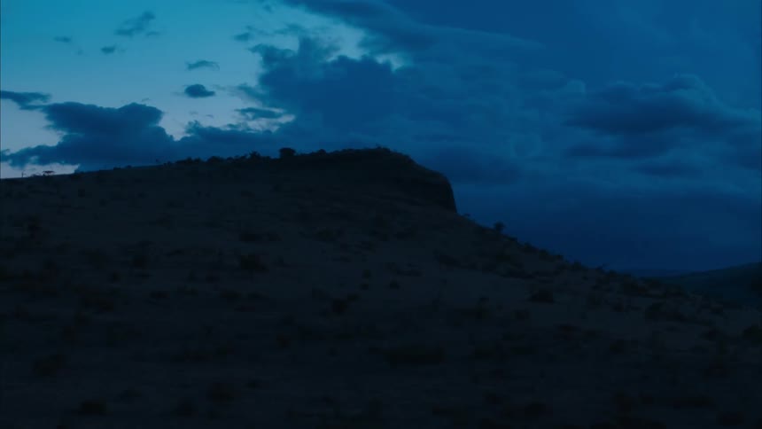 Dark clouds floating over a hill in nature