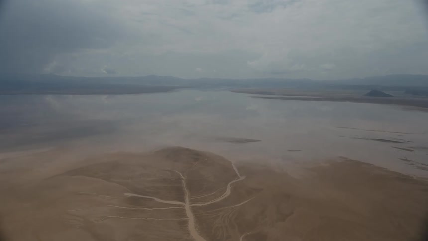 Aerial view of a shallow lake on the sand plains under the clouds