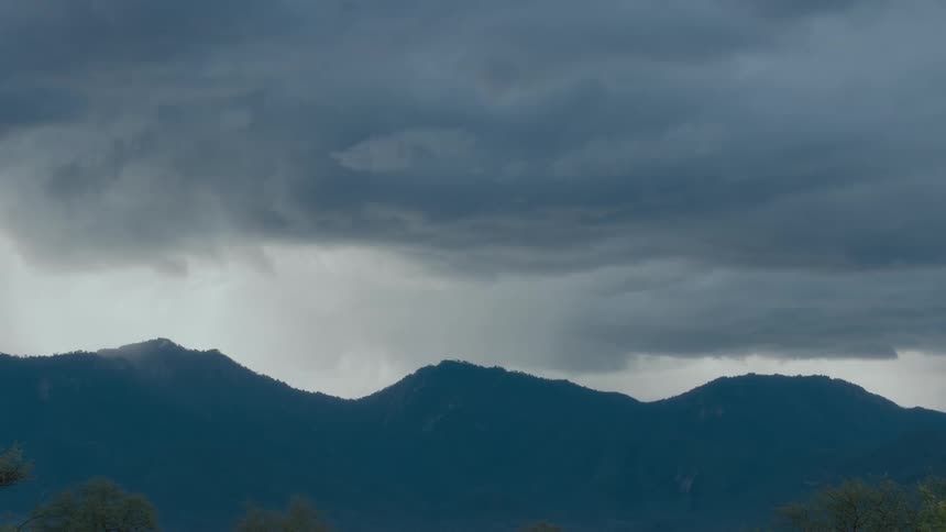 Gray clouds sit over misty mountains