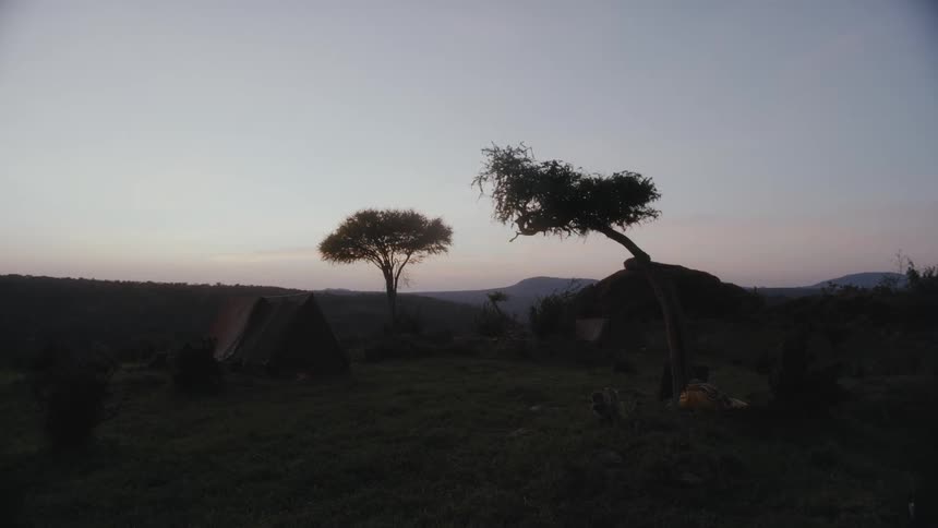 A tent is set up near a tent in an open field