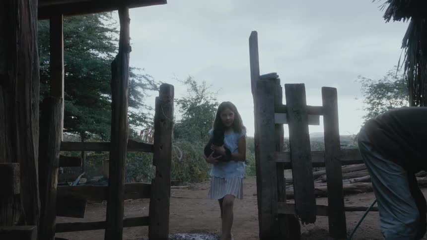A girl carries a black cat