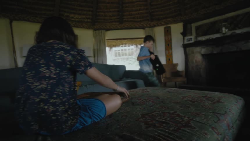 Two children play around in the room