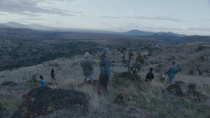 People stand together on the windy hills