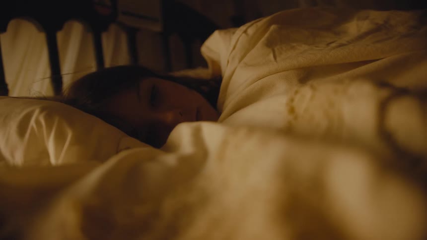 A girl is sleeping in bed