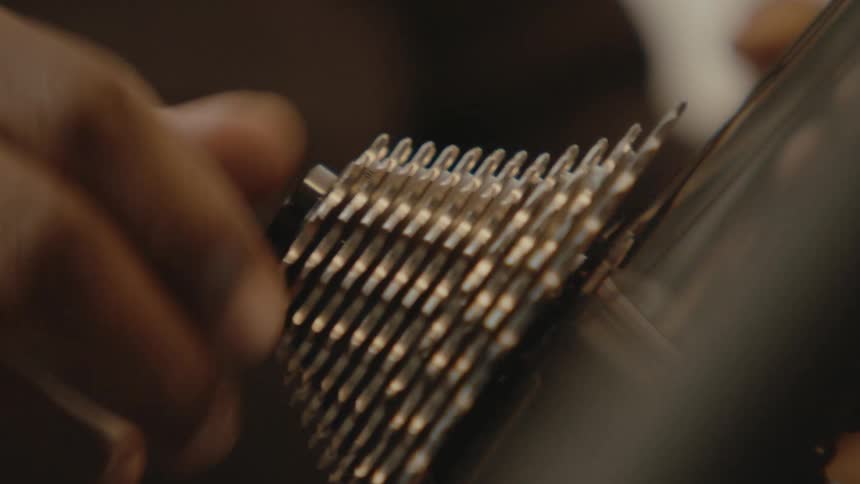 A person turning gears on a bike wheel