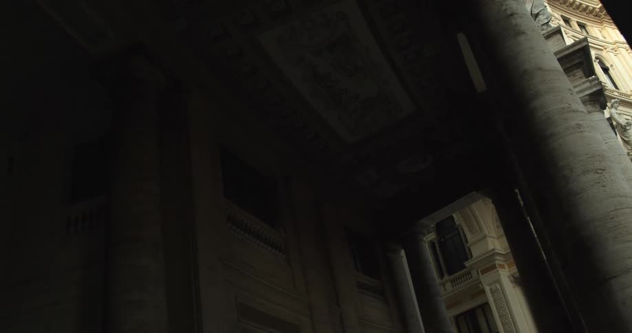 Large stone pillars on on the side of the building