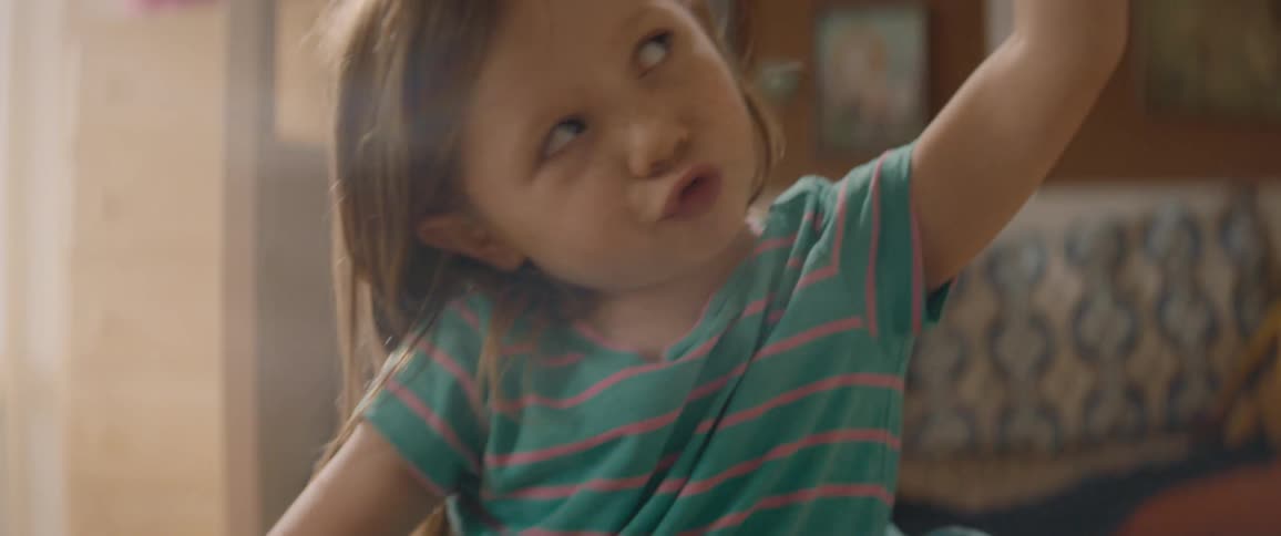 A little girl is in her room playing with a toy rocket