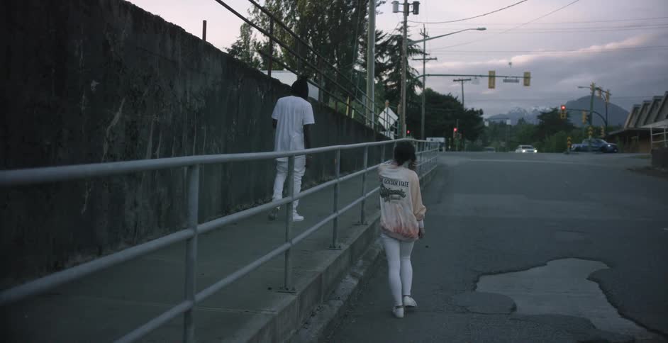 Man and woman walking down a street
