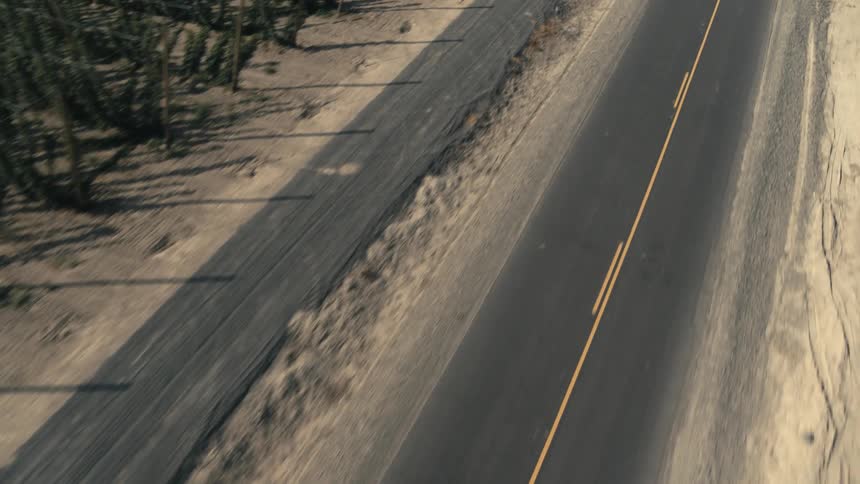 Aerial view of a rural road and white pickup truck passes by