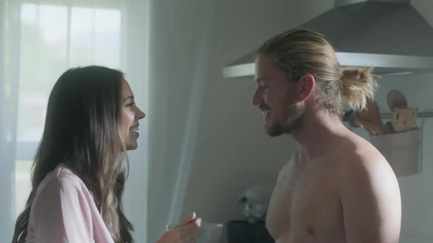 A woman feeds a man from a bowl