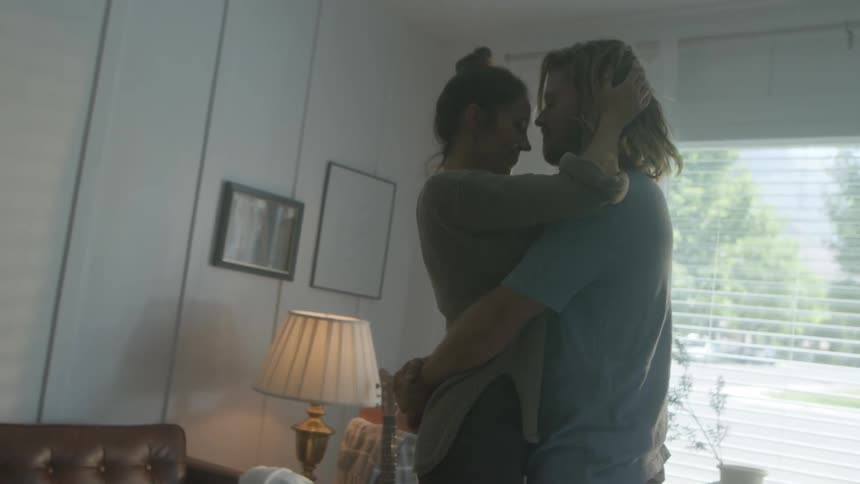 A couple dance together at home