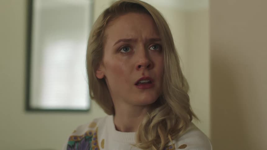 A woman looks shocked