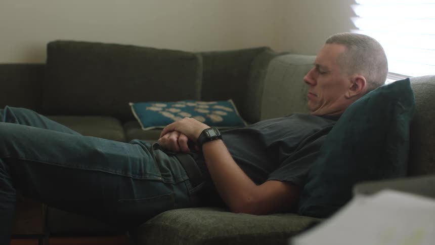 A man gets up from a nap