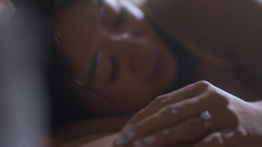 A couple lay in bed together