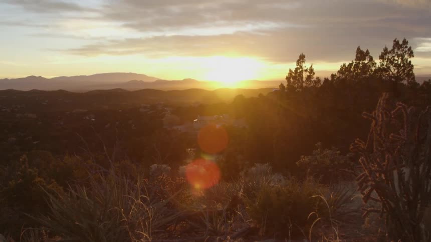 The sun is setting on the distance on this desert