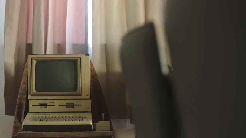 An old computer is near the window
