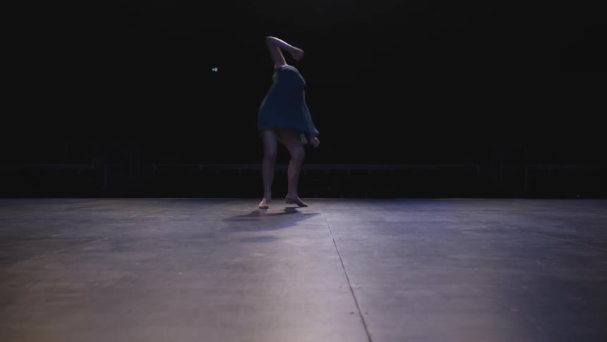 Ballerina twirls around and dances on stage