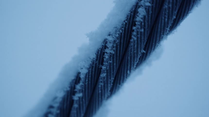 Snow and ice on a twisted metal rope