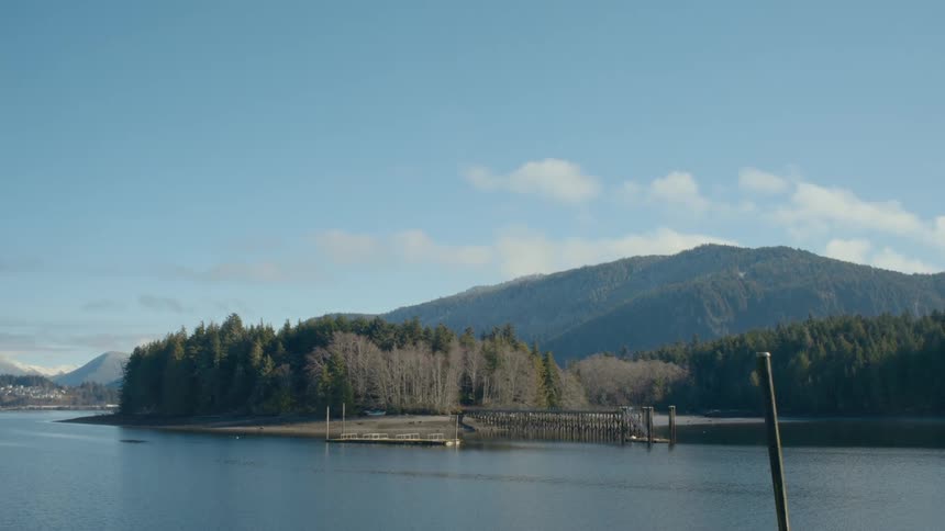 A pier is on the river by the mountains