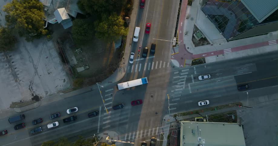 Several vehicles travel through an intersection before coming to a halt in traffic