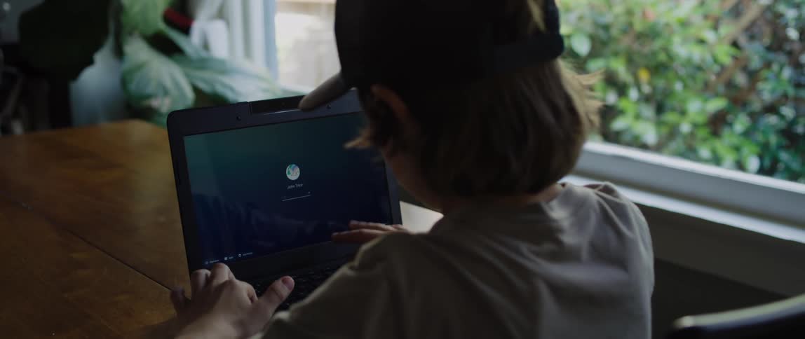 A boy open his laptop and types